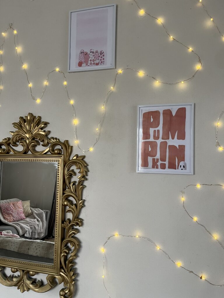 DIY printed wall art with gold mirror and warm fairy lights